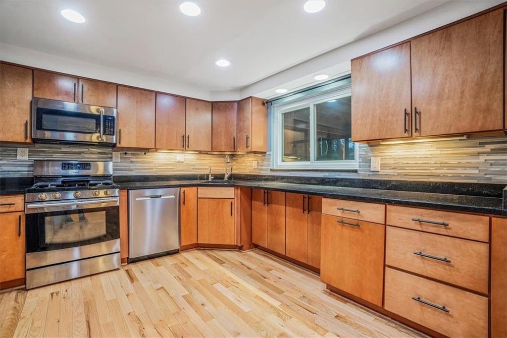 2341 Sample Road Allison Park, PA 15101 - Photo 9 of 50 a kitchen with stainless steel appliances granite countertop wooden cabinets a sink and a stove
