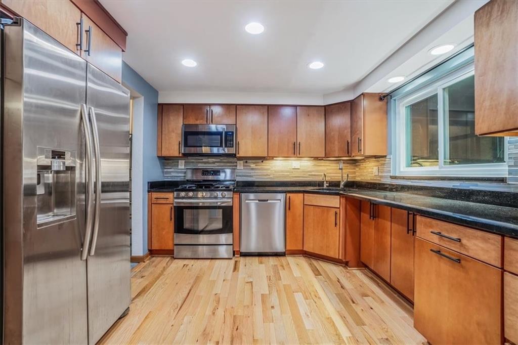 2341 Sample Road Allison Park, PA 15101 - Photo 10 of 50 a kitchen with stainless steel appliances granite countertop a stove a sink and a refrigerator