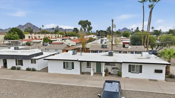 a view of a white house next to a road