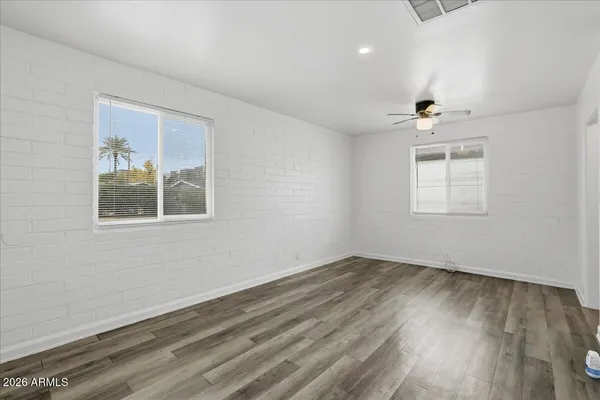 a view of empty room with wooden floor