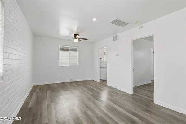 a kitchen with granite countertop a sink stove and refrigerator