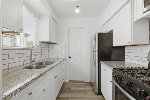 a kitchen that has a sink and a stove