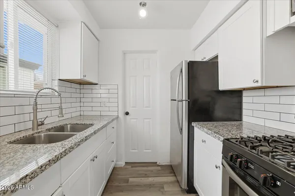 a kitchen with a sink and a refrigerator