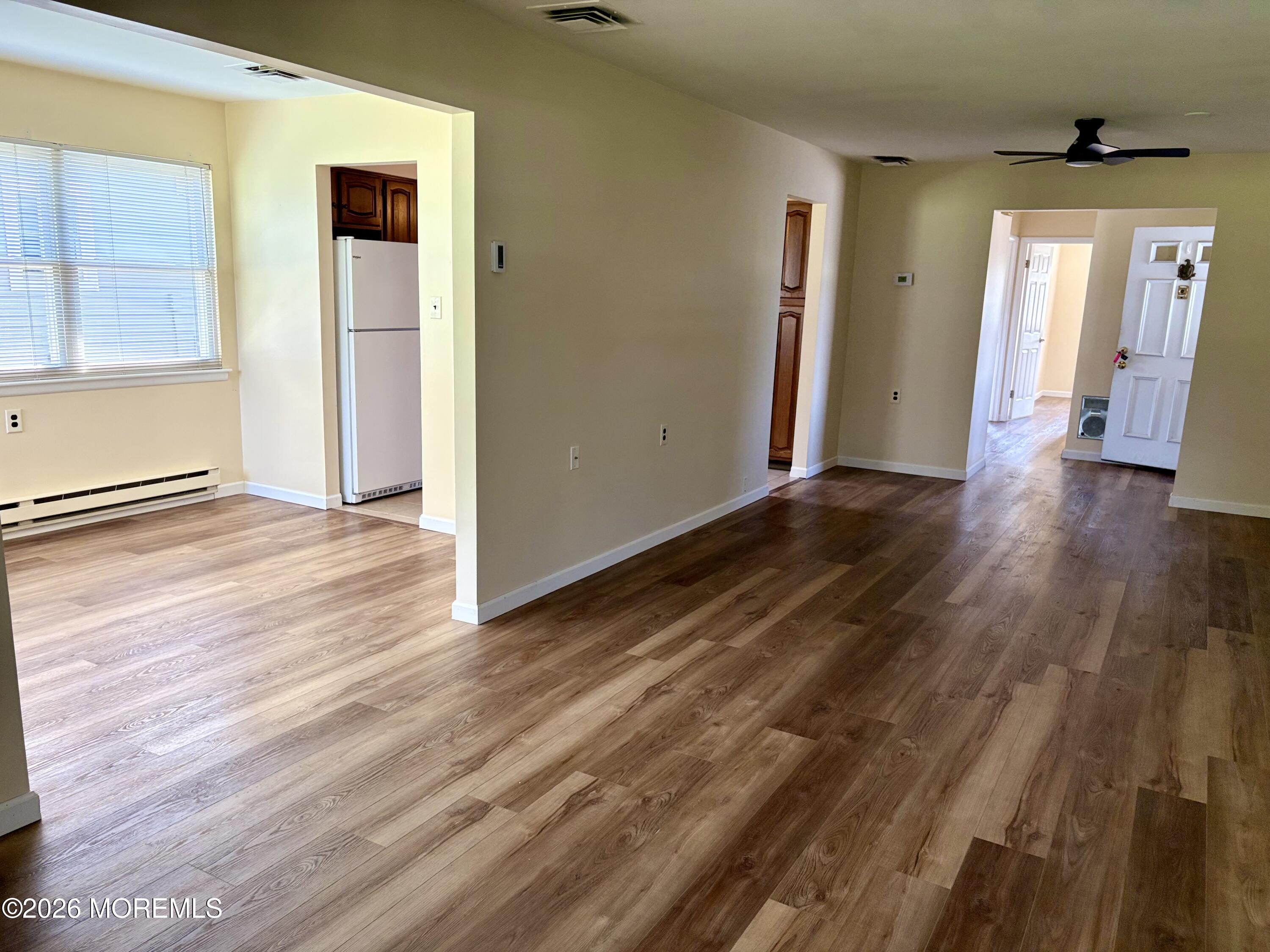 8 Dryden Road Brick, NJ 08724 - Photo 9 of 35 an empty room with wooden floor and windows