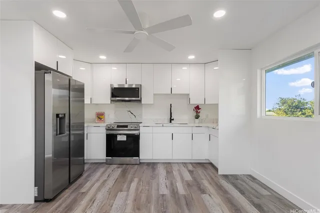 a kitchen with granite countertop stainless steel appliances a sink and counter space