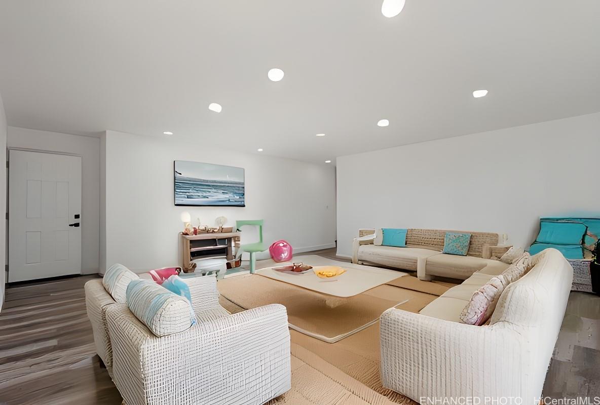 84-1036 Noholio Road Waianae, HI 96792 - Photo 2 of 25 Enhanced photo of downstairs living room with virtual staging. Door to the left leads to the third bedroom