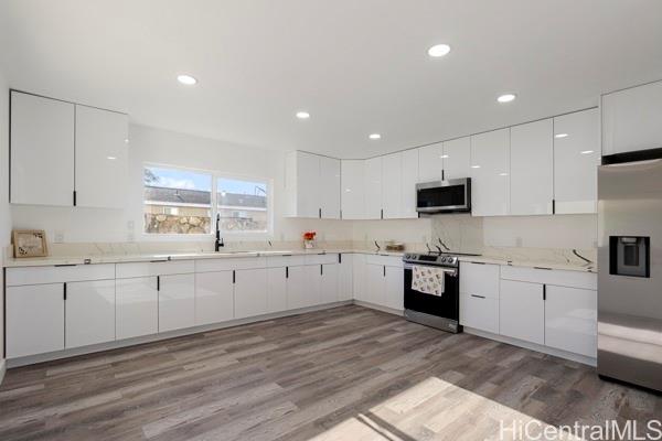 84-1036 Noholio Road Waianae, HI 96792 - Photo 3 of 25 downstairs kitchen - new cabinets and quartz countertops. Stainless steel appliances!