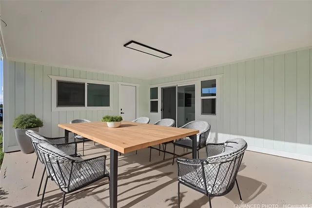 a view of a dining table and chairs in porch