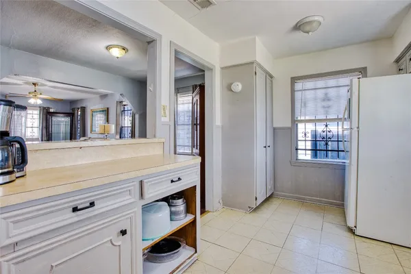a spacious bathroom with a shower a mirror and a sink
