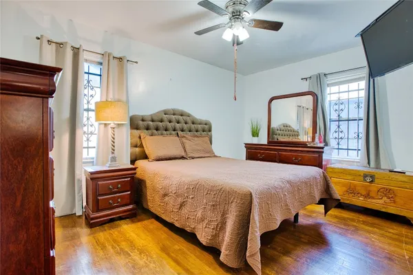 a bedroom with a bed lamps and dresser