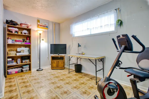 a bedroom with a bed and a flat tv screen tv on the dresser