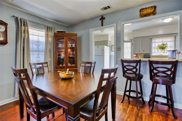 a view of a dining room with furniture and window