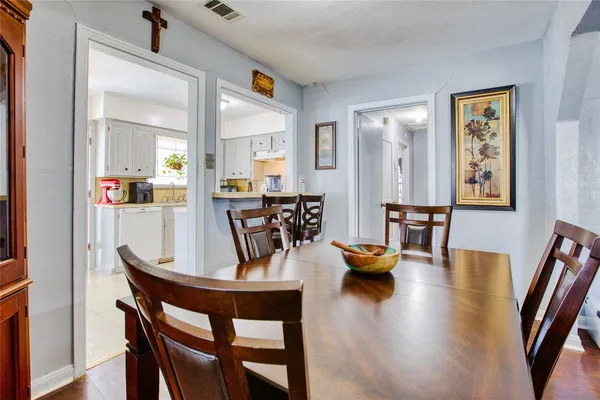 a view of a dining room with furniture and wooden floor