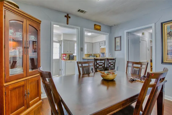 a dining room with furniture and wooden floor