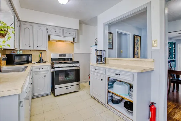 a kitchen with granite countertop a stove and a sink