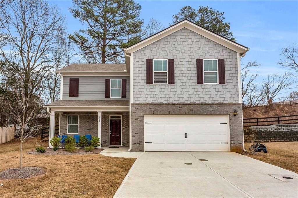 a front view of a house with a yard and garage