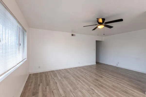 wooden floor in an empty room with a window