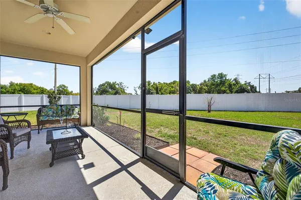a living room with furniture and a floor to ceiling window