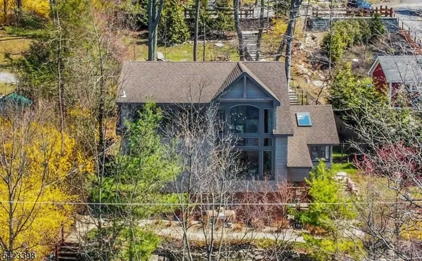 a view of a house with a tree and plants