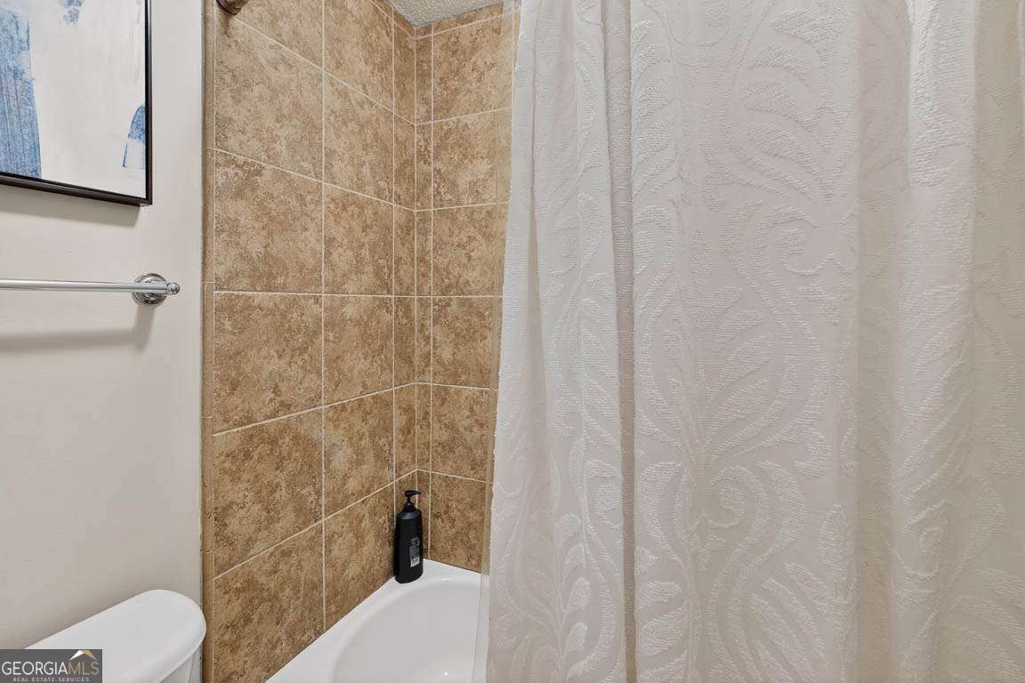 2514 Demere Road, Unit 7 St. Simons, GA 31522 - Photo 22 of 22 a bathroom with a shower and a toilet