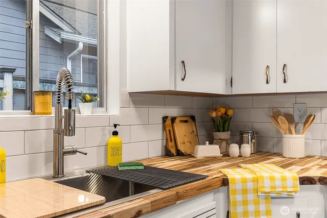 a kitchen with a sink and a stove top oven