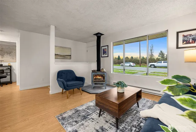 a living room with furniture and a floor to ceiling window