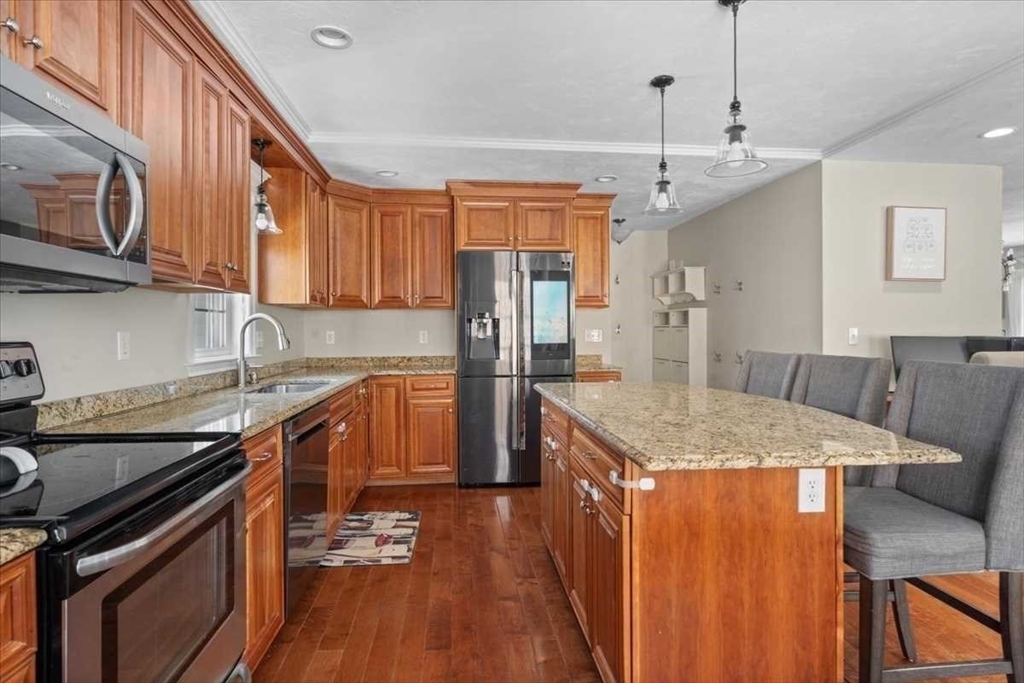 57 Partridge Hill Road Sutton, MA 01590 - Photo 12 of 40 a kitchen with stainless steel appliances granite countertop a sink stove and refrigerator