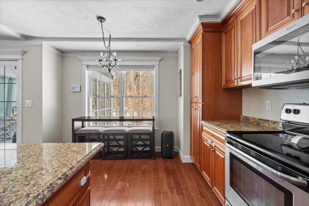 57 Partridge Hill Road Sutton, MA 01590 - Photo 13 of 40 a kitchen with granite countertop a stove and a sink