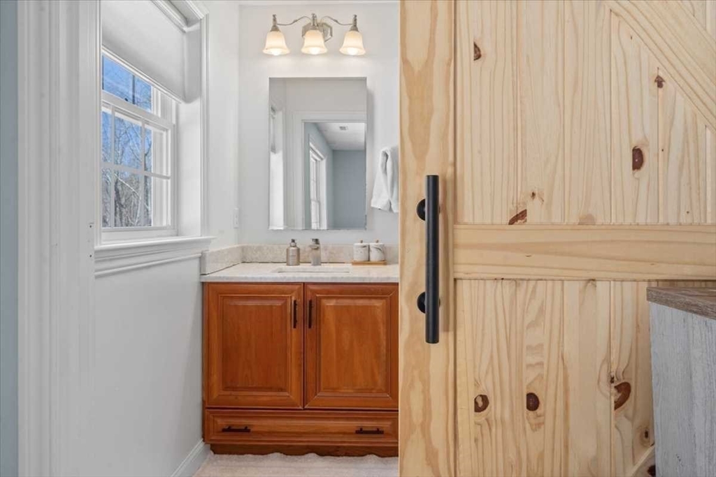 57 Partridge Hill Road Sutton, MA 01590 - Photo 17 of 40 a bathroom with a sink and a mirror