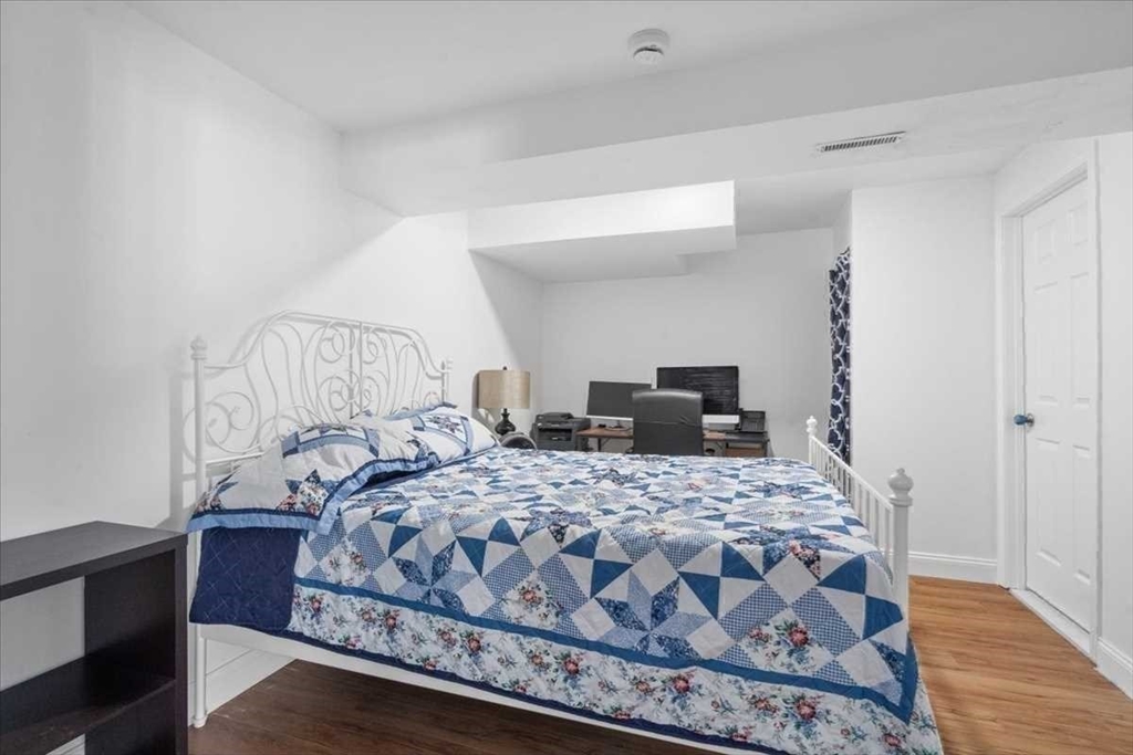 57 Partridge Hill Road Sutton, MA 01590 - Photo 23 of 40 a bedroom with a bed and wooden floor