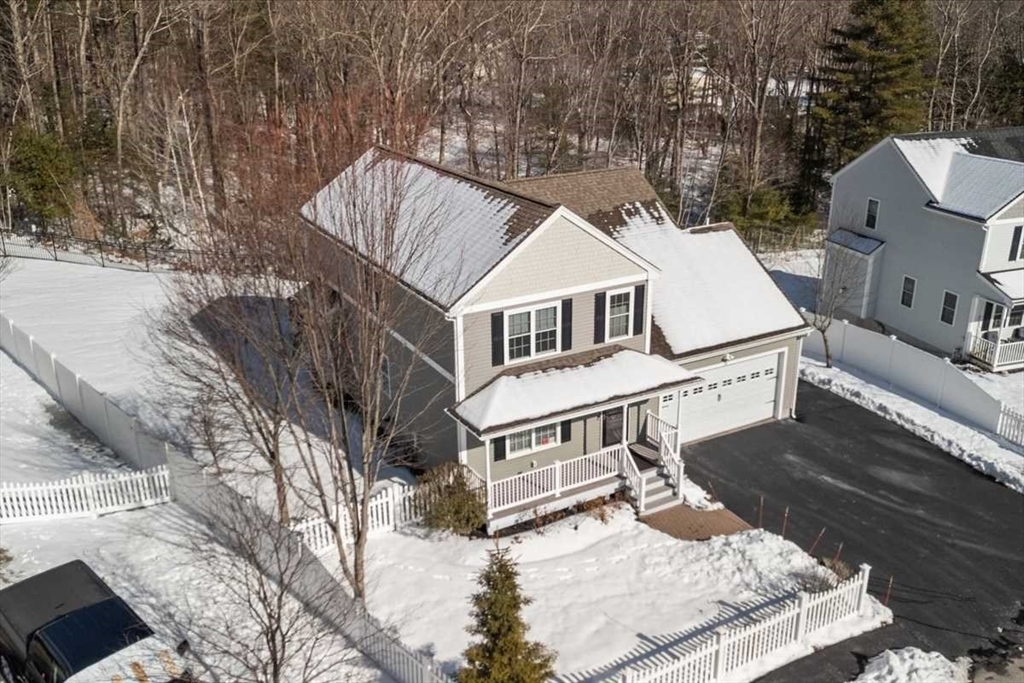 57 Partridge Hill Road Sutton, MA 01590 - Photo 5 of 40 with white house with a large pool and lawn chairs under an umbrella