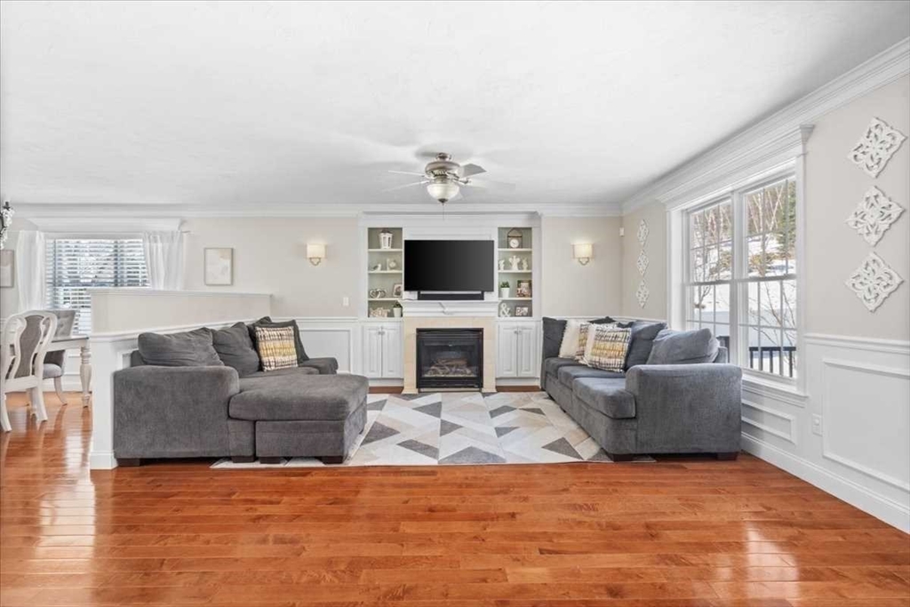 57 Partridge Hill Road Sutton, MA 01590 - Photo 7 of 40 a living room with furniture a fireplace and a flat screen tv
