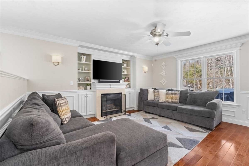 57 Partridge Hill Road Sutton, MA 01590 - Photo 8 of 40 a living room with furniture a fireplace and a flat screen tv