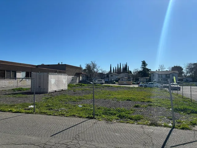 a view of a house with a yard and a street