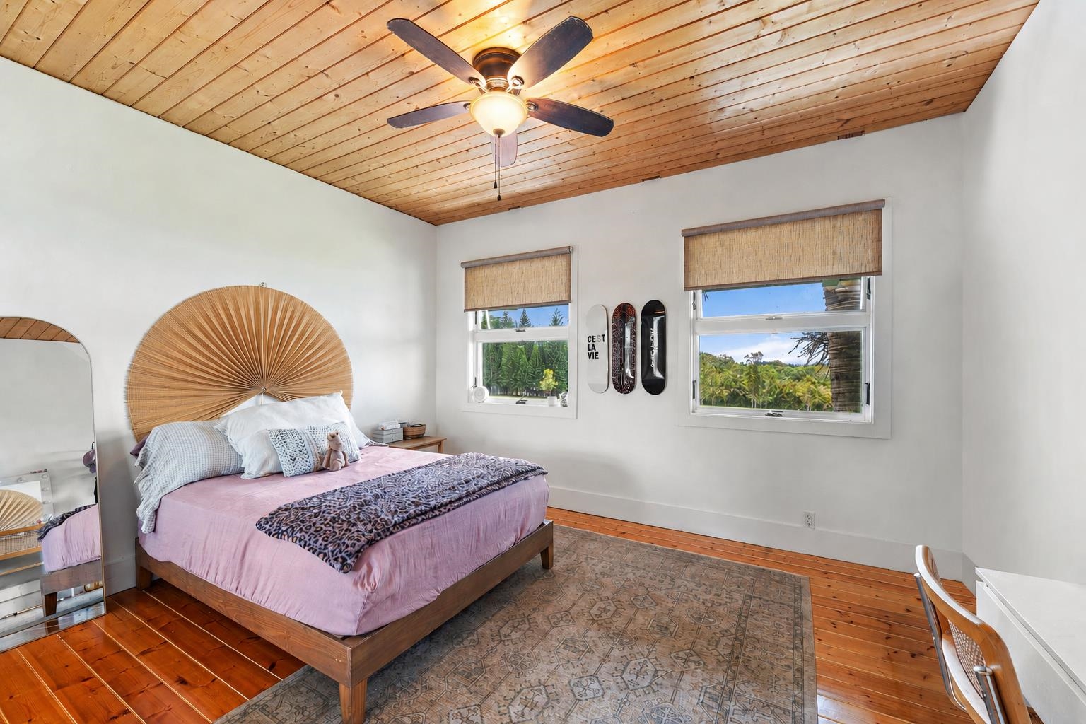 1949 West Kuiaha Road Haiku, HI 96708 - Photo 20 of 49 a bedroom with a bed and a chandelier