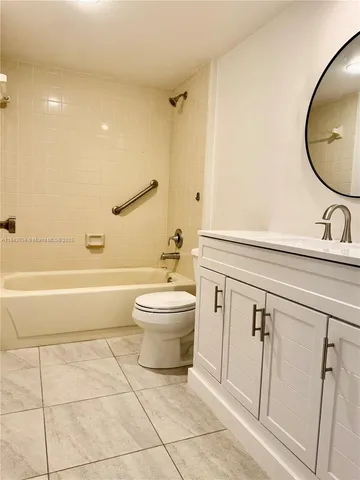 a bathroom with a toilet a sink and bathtub