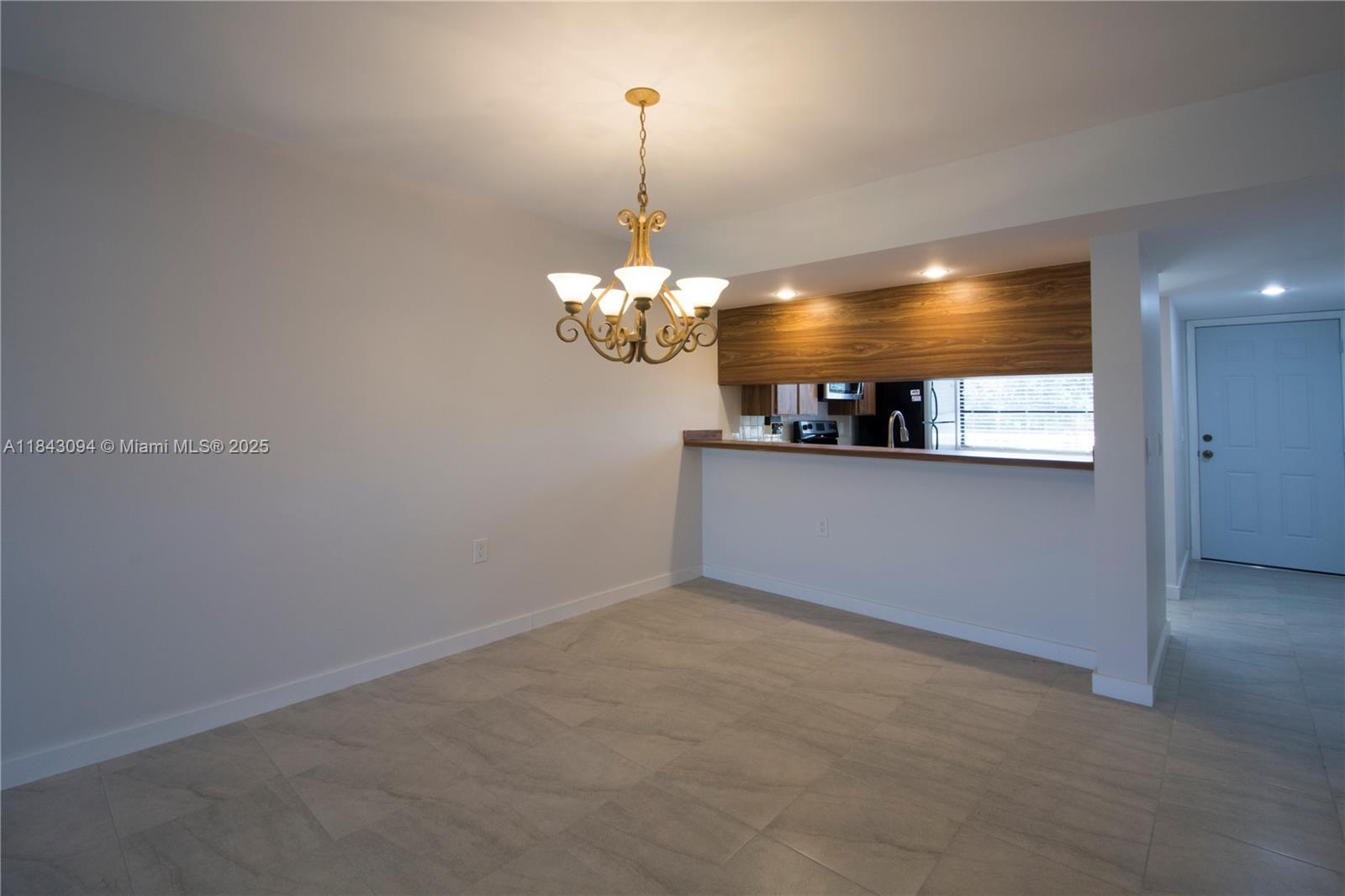 1717 Whitehall Drive, Unit 201 Davie, FL 33324 - Photo 4 of 18 a view of a room with a chandelier