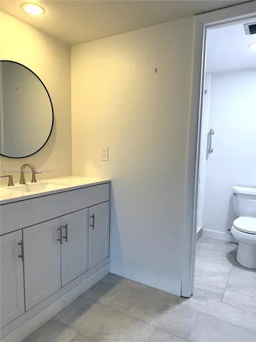 a spacious bathroom with a double vanity sink and a mirror
