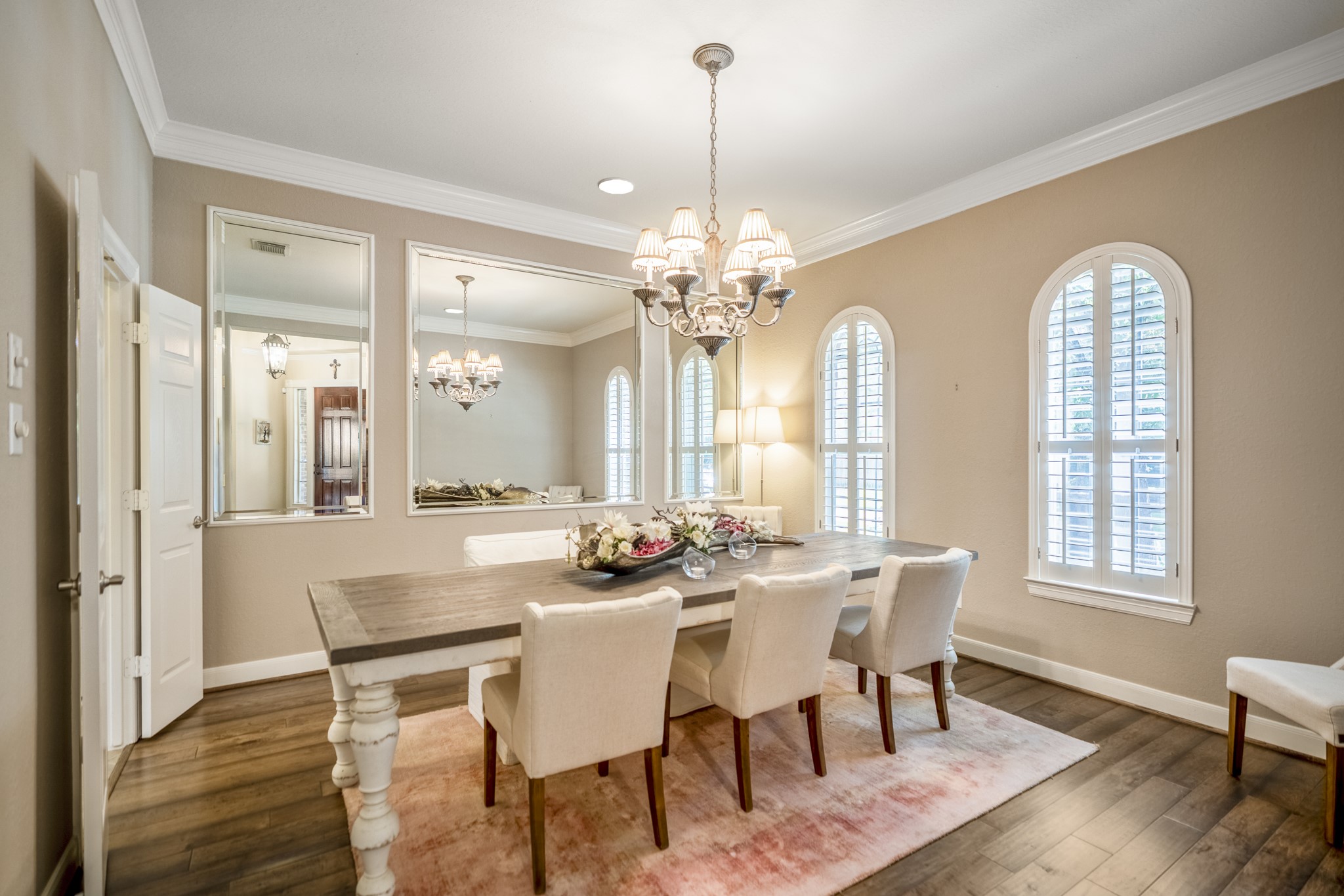 67 North Pentenwell Circle Spring, TX 77382 - Photo 5 of 50 a dining room with wooden floor a chandelier a wooden table and chairs