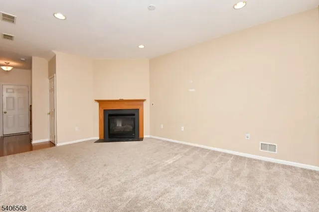 a view of an empty room with a fireplace