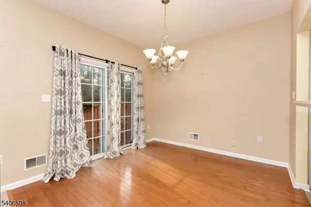 a view of a livingroom with wooden floor and a window