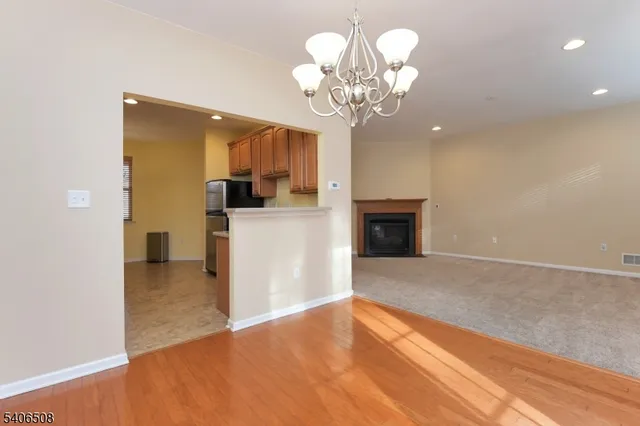 a view of a livingroom with a chandelier furniture and a fireplace