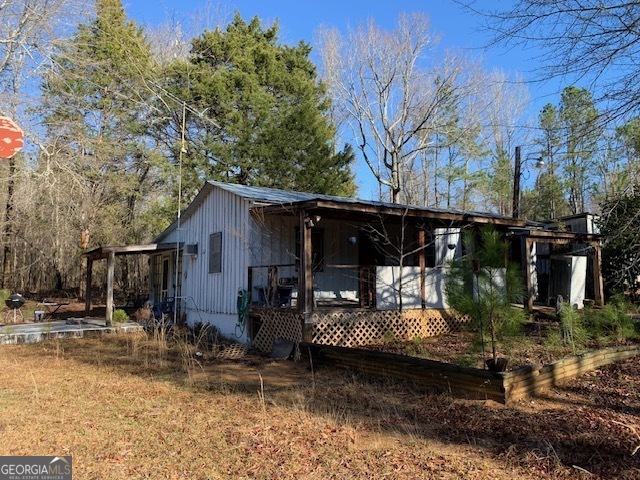121 County Line Church Road Southwest Milledgeville, GA 31061 - Photo 1 of 1 a view of a house with a yard