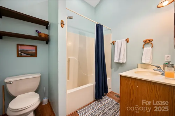 a bathroom with a sink vanity mirror and toilet