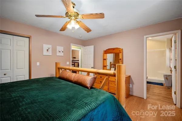 a bedroom with a bed and a view of balcony