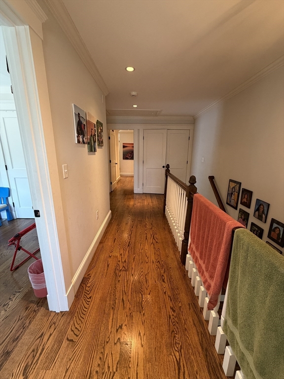 17 Cardinal Street, Unit 17 Winchester, MA 01890 - Photo 27 of 42 a view of an empty room with wooden floor and stairs