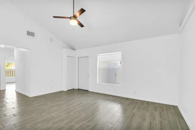 wooden floor in an empty room with a window