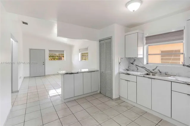 a bathroom with a sink a toilet and large mirror