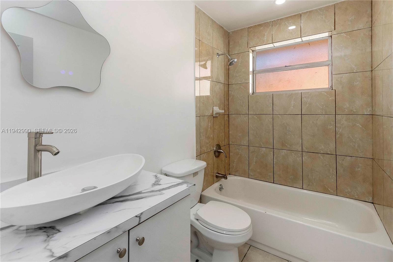 642 East 2nd Avenue, Unit A Hialeah, FL 33010 - Photo 8 of 14 a bathroom with a sink a toilet and bathtub