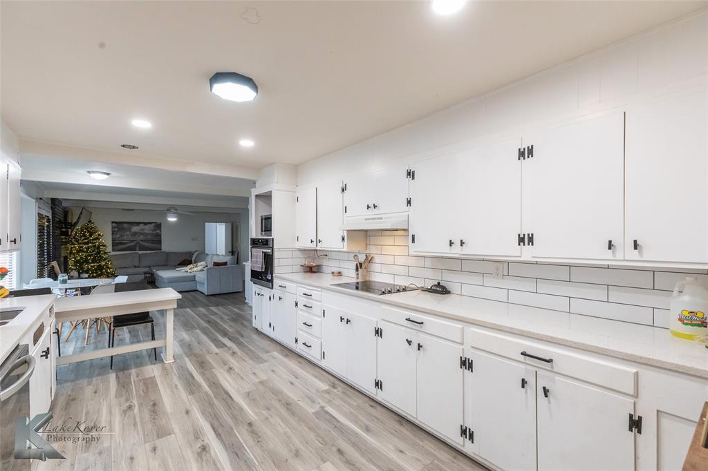1909 River Oaks Road Abilene, TX 79605 - Photo 13 of 40 a kitchen with white cabinets and sink